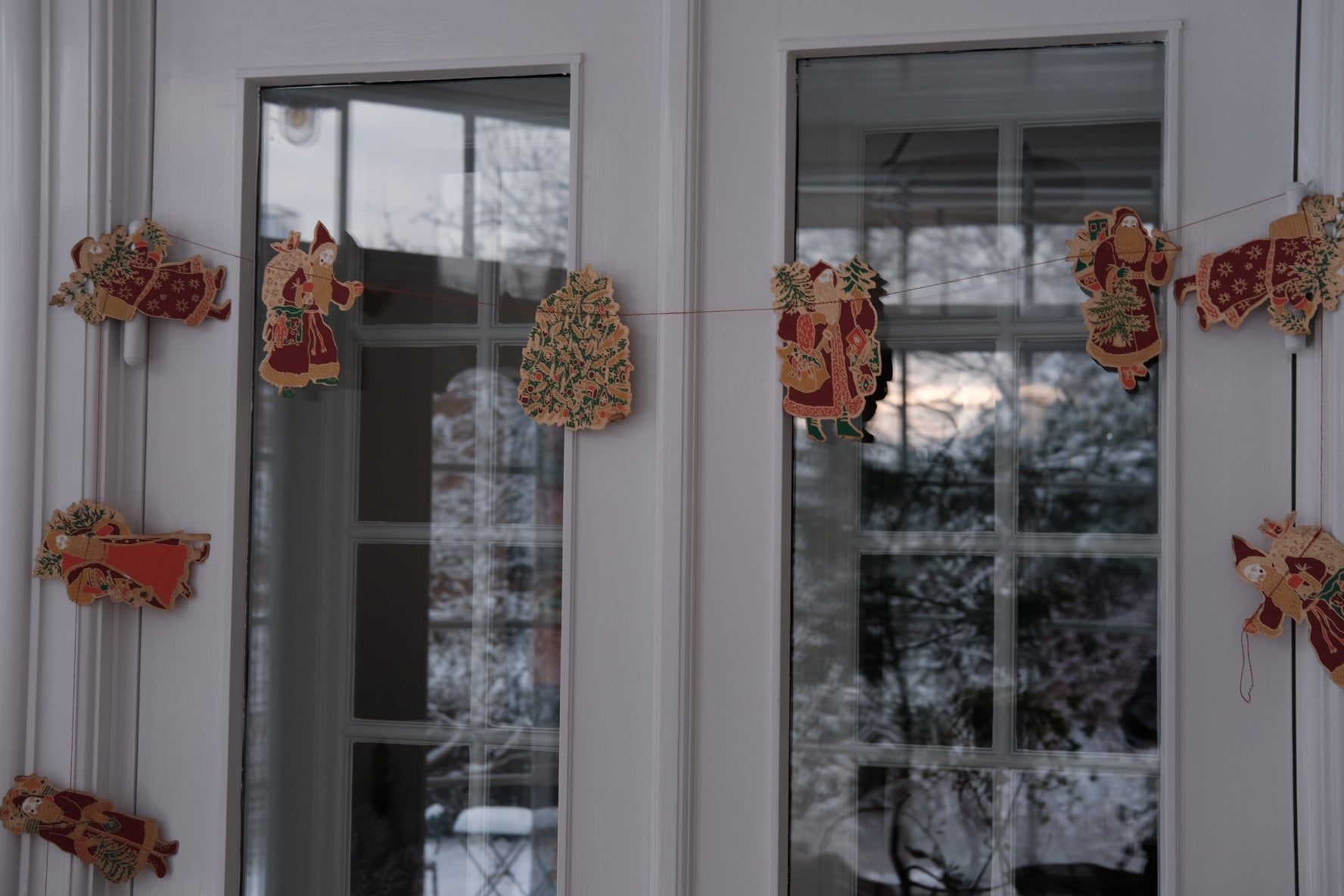 Colorful Saint Nicholas Christmas garland by East End Press, featuring festive Julemand characters for holiday decoration.