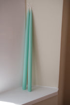 Mint-colored hand-dipped stearin candle, 45 cm tall, from Kunstindustrien, with a smooth, tapered design.