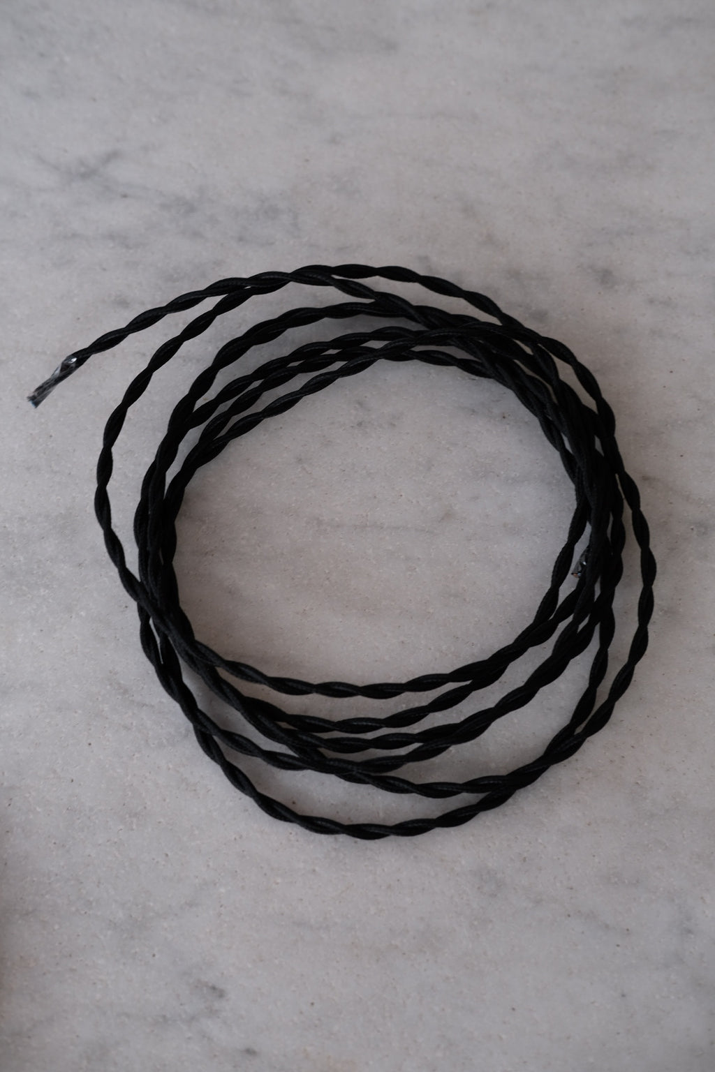 DORA Snoet 3 m black ledning with a sleek, flexible design, showcasing its durable material and practical use.