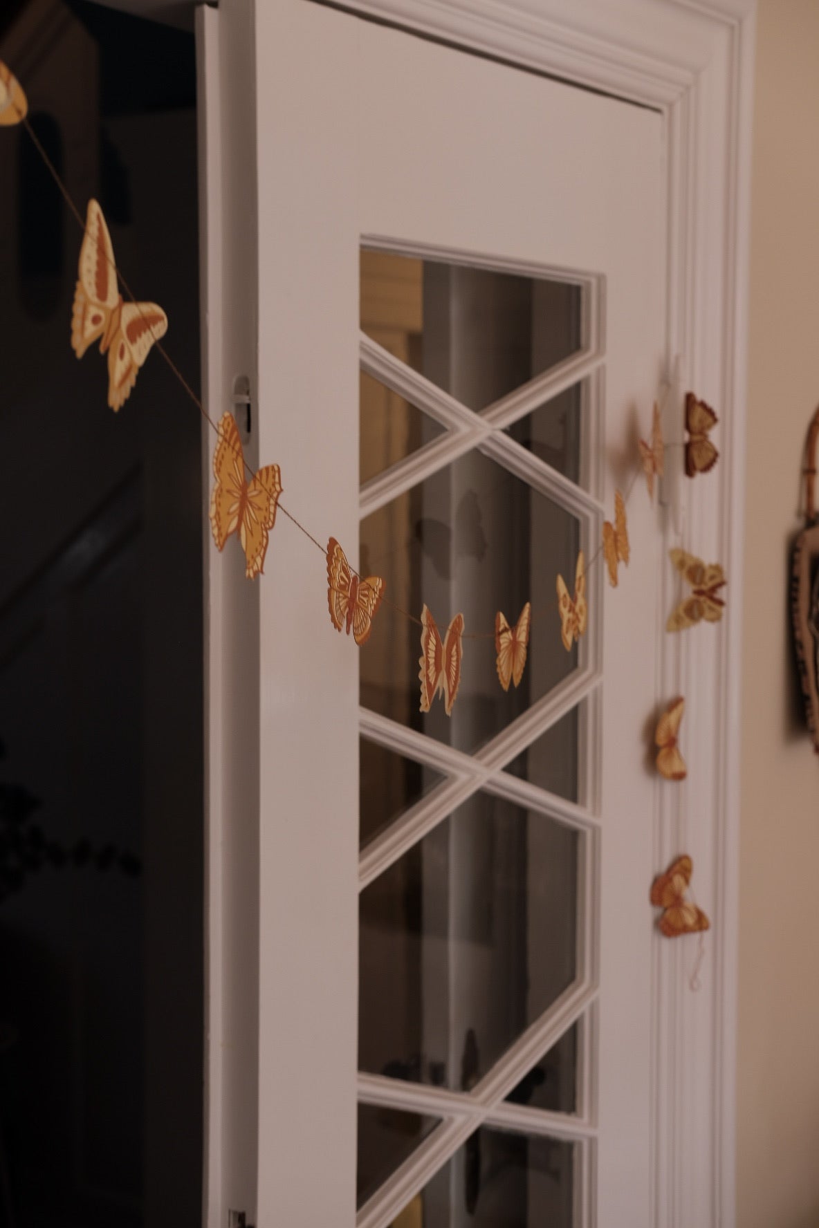 Colorful butterfly garland from East End Press, featuring delicate butterflies strung together for decorative display.