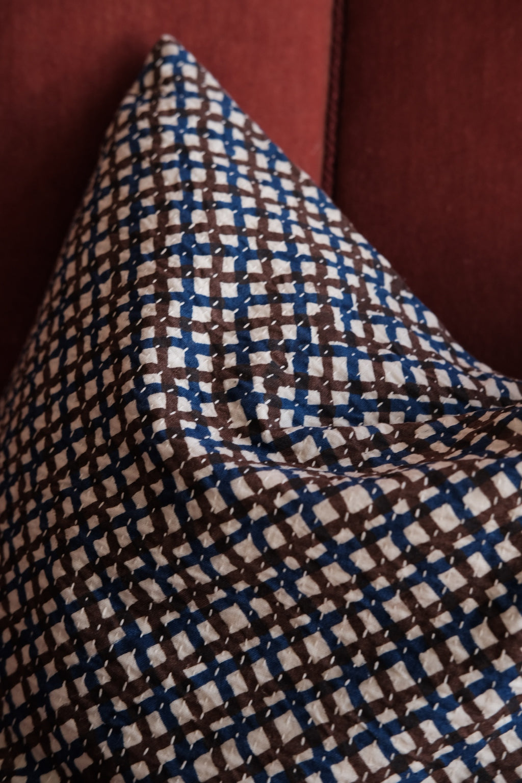 Blue and brown checkered cotton throw pillow from A World of Craft, 50x50 cm, with a cozy, textured fabric design.