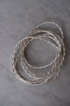 DORA Råhvid Snoet 3 m ledning displayed with a textured, twisted design and natural color.