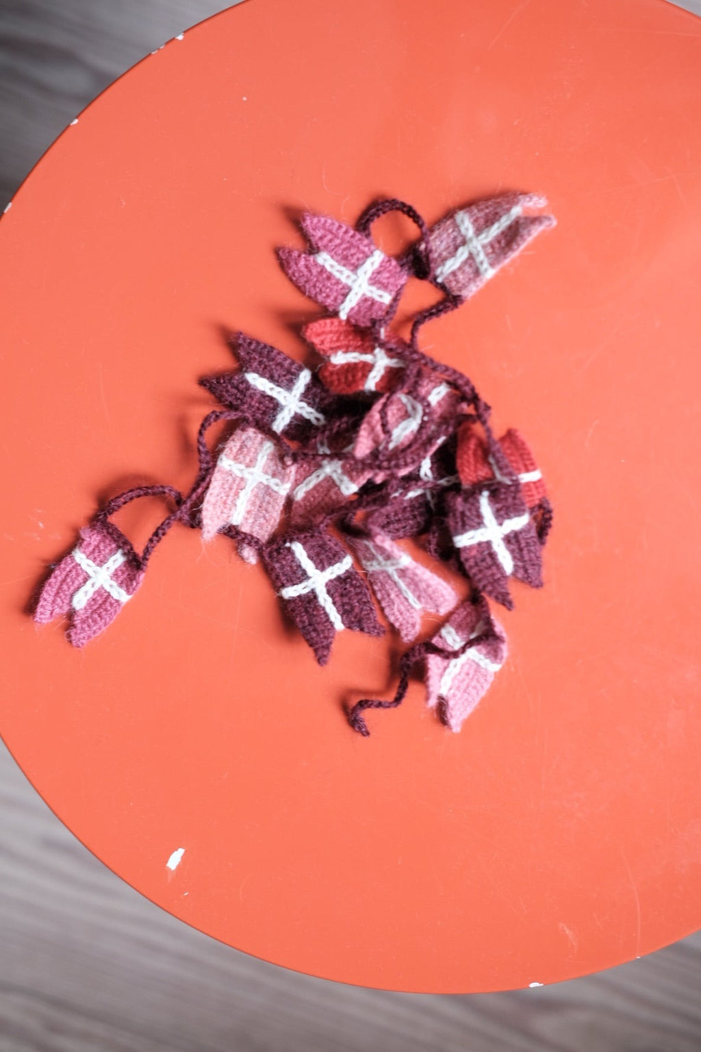 Red crocheted flag garland from Creme de la Creme de la Helle, 1.5 meters long, featuring colorful fabric flags on a string.