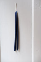 Set of four marine blue hand-dipped stearinlys, 28 cm tall, from Kunstindustrien, shown with their textured, handcrafted appearance.