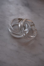 Set of two Marqversen Möglich glass napkin rings with clear, hand-blown design and circular shape.