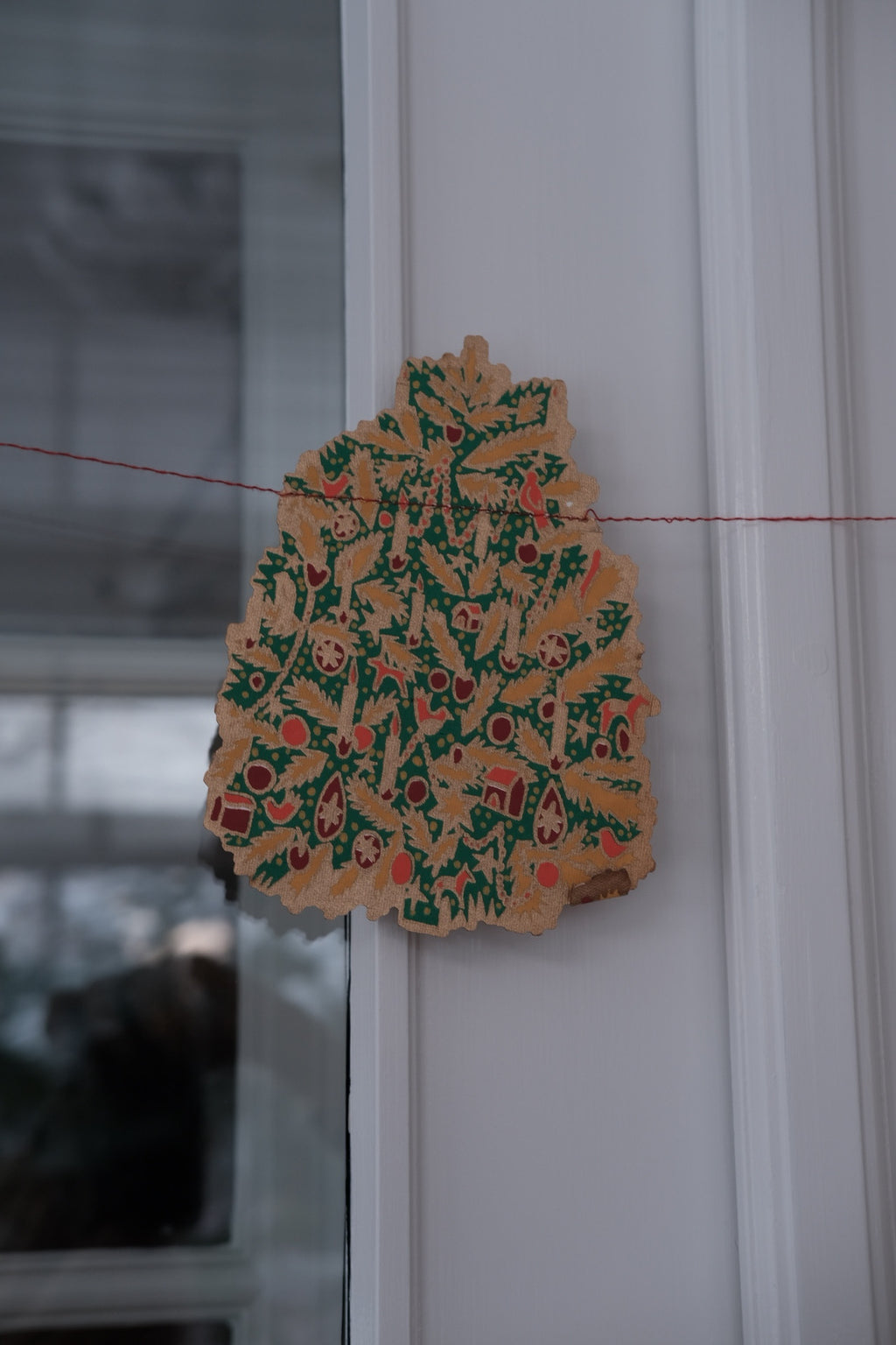 East End Press Saint Nicholas Christmas garland with festive holiday decorations and colorful ornaments.