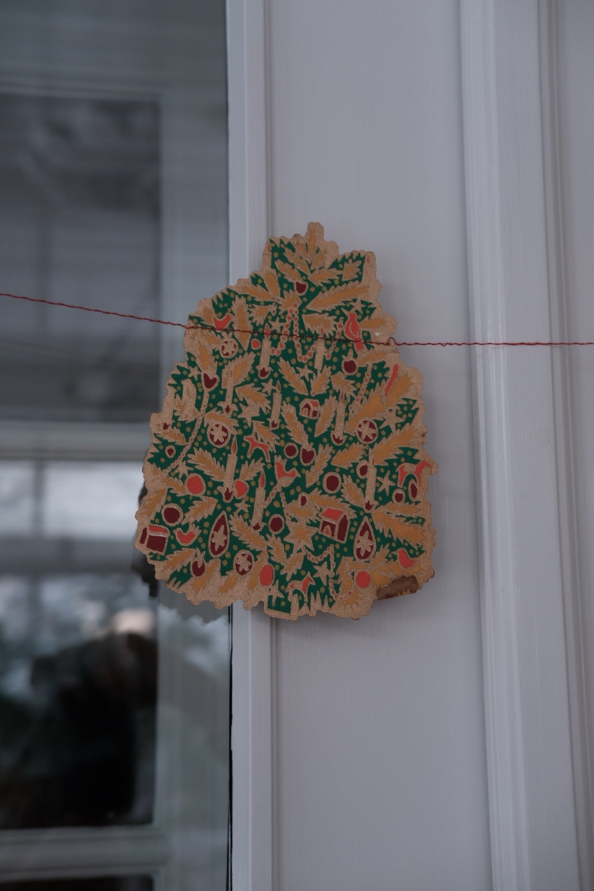 East End Press Saint Nicholas Christmas garland with festive holiday decorations and colorful ornaments.