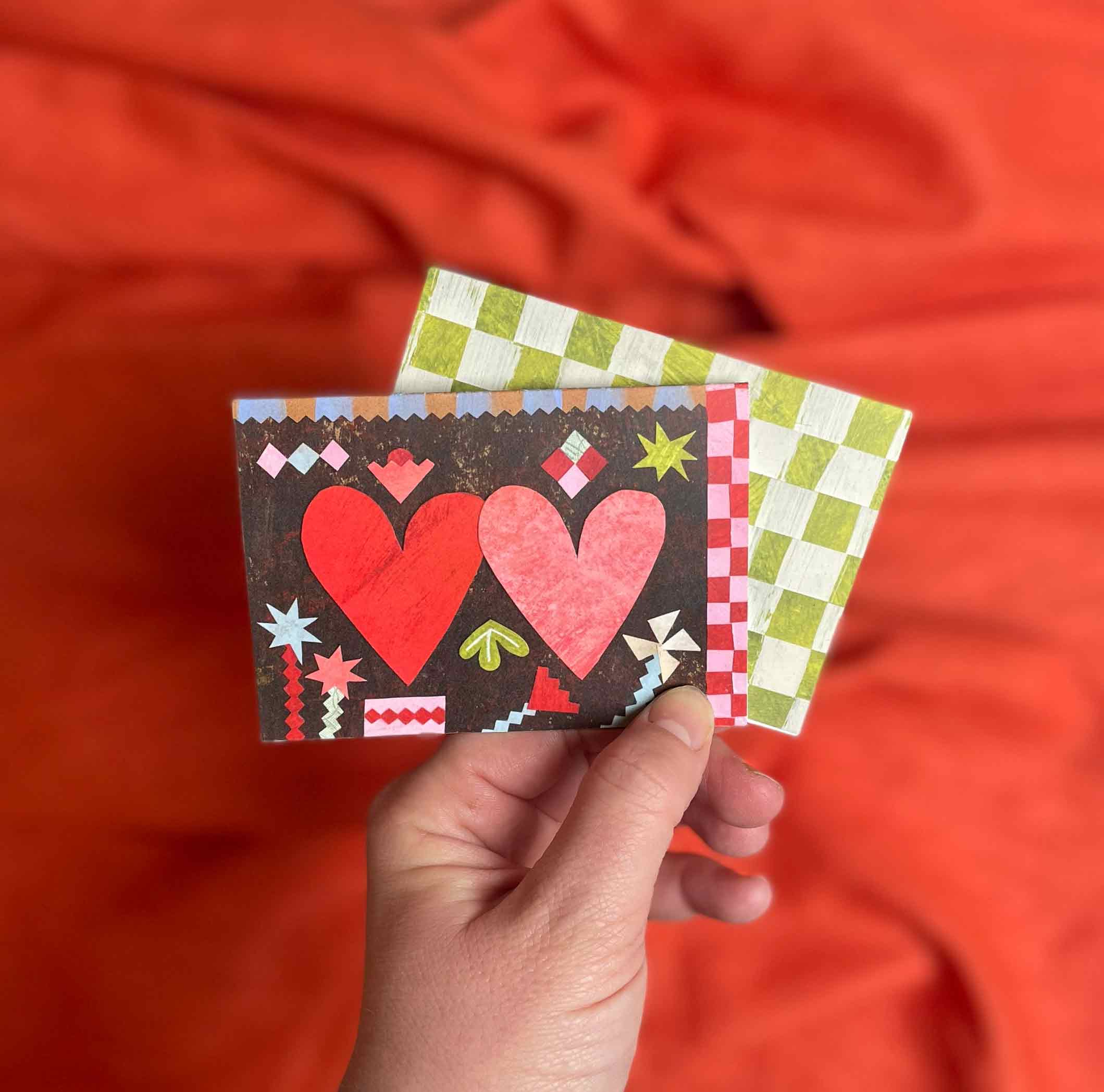 Mini heart-themed greeting card by Mortlake Papers featuring a charming design with red and pink hearts.