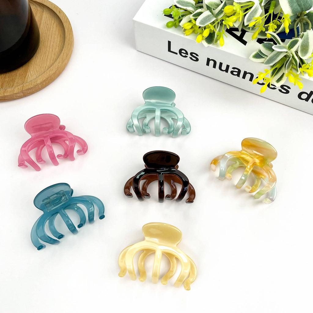 Pink DORA hair clip with medium size, stylish hair accessory for securing hair in a natural and versatile way.