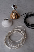 DORA Ledning Snoet 3 m in raw white, showcasing its twisted design and flexible length for various uses.