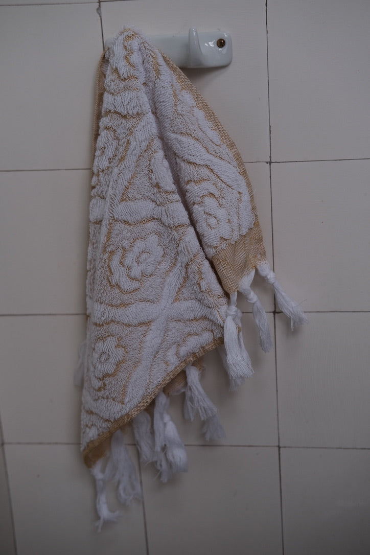 Yellow DORA hand towel, 50x30 cm, soft and absorbent, displayed folded on a clean surface.