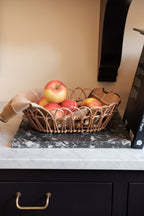 Large rattan bread basket by Bungalow with a woven design, ideal for serving bread on the table.