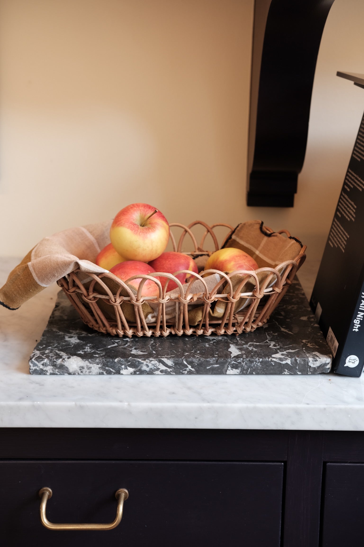 Large rattan bread basket by Bungalow with a woven design, ideal for serving bread on the table.