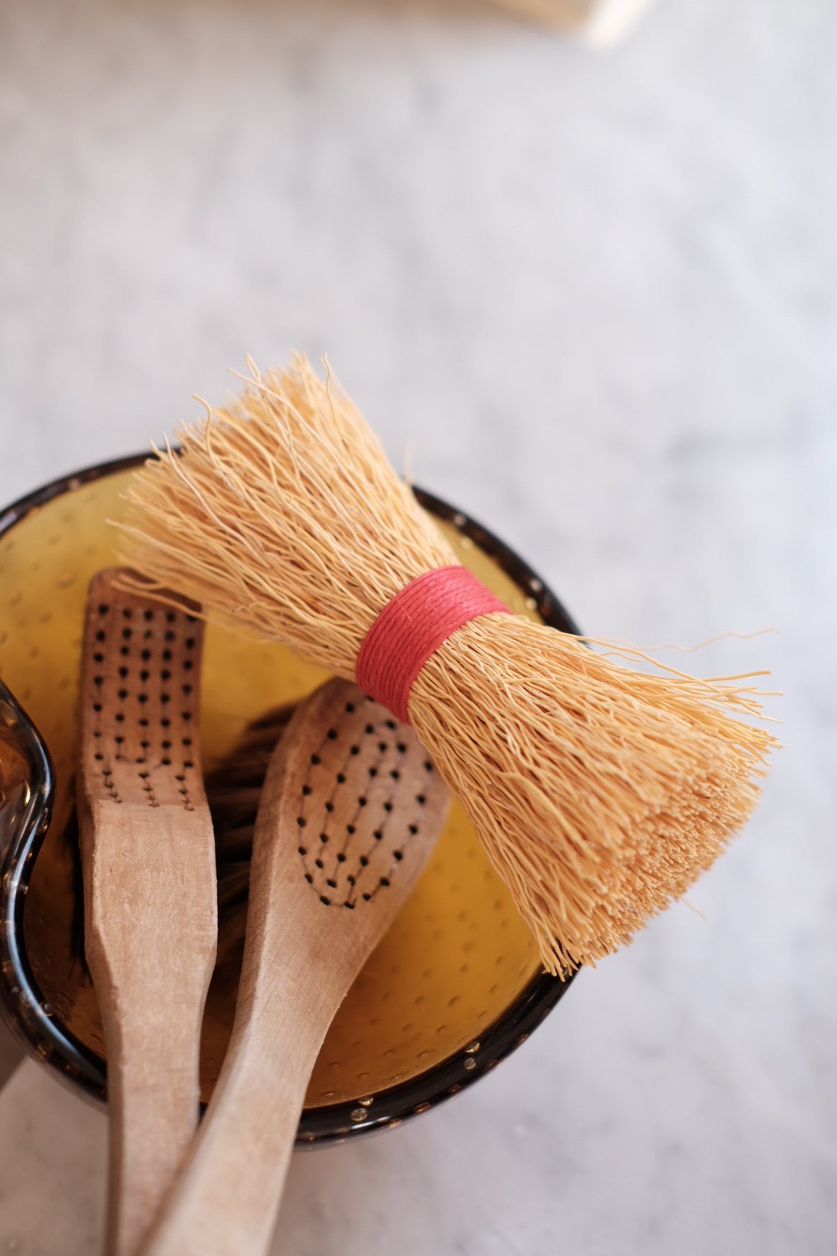 Red Iris Hantverk dish brush with a wooden handle and natural bristles, designed for cleaning dishes and kitchenware.