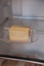 Clear butter dish by Heim Söhne, made of glass, with a lid and base for serving and storing butter.