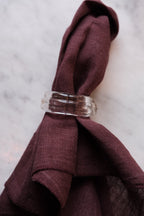 Set of two Marqversen Möglich blown glass napkin rings with clear, rounded design, perfect for elegant table settings.
