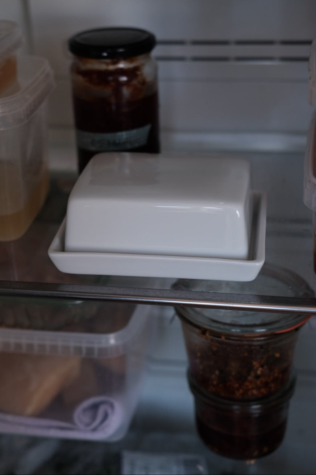 Stor smørskål i porcelæn fra DORA, rund form med glat hvid overflade og plads til smør.