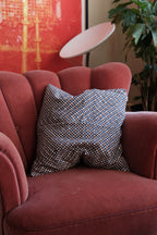 A blue and brown checkered cotton cushion from A World of Craft, measuring 50x50 cm, with a soft, textured fabric appearance.