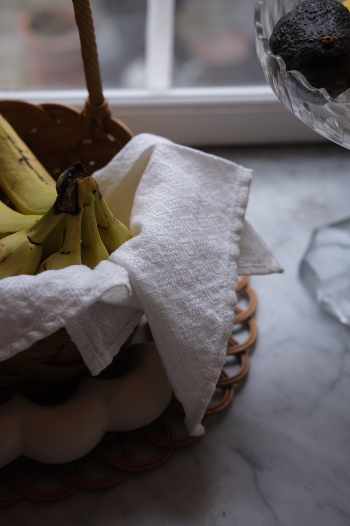 White linen embroidered napkin with delicate border, elegant serviet from Linge Particulier for refined table settings.