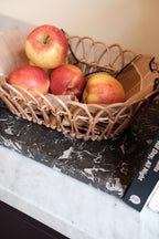 Large rattan bread basket with woven design, ideal for serving bread and baked goods in a rustic kitchen setting.