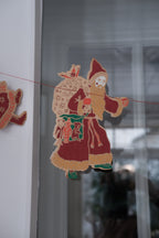 East End Press Saint Nicholas Christmas garland with festive holiday decorations and colorful elements on a holiday-themed background.