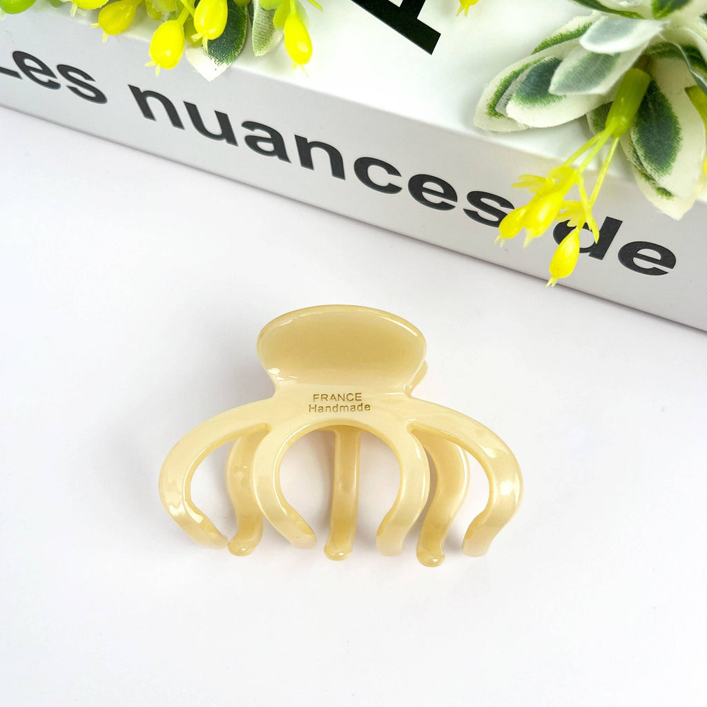 DORA pink hair clip with medium size, stylish hair accessory shown in close-up with a smooth, curved design.