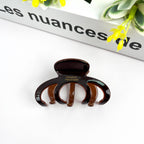 Pink medium DORA hair clip with a sleek, curved design, perfect for styling medium-length hair.