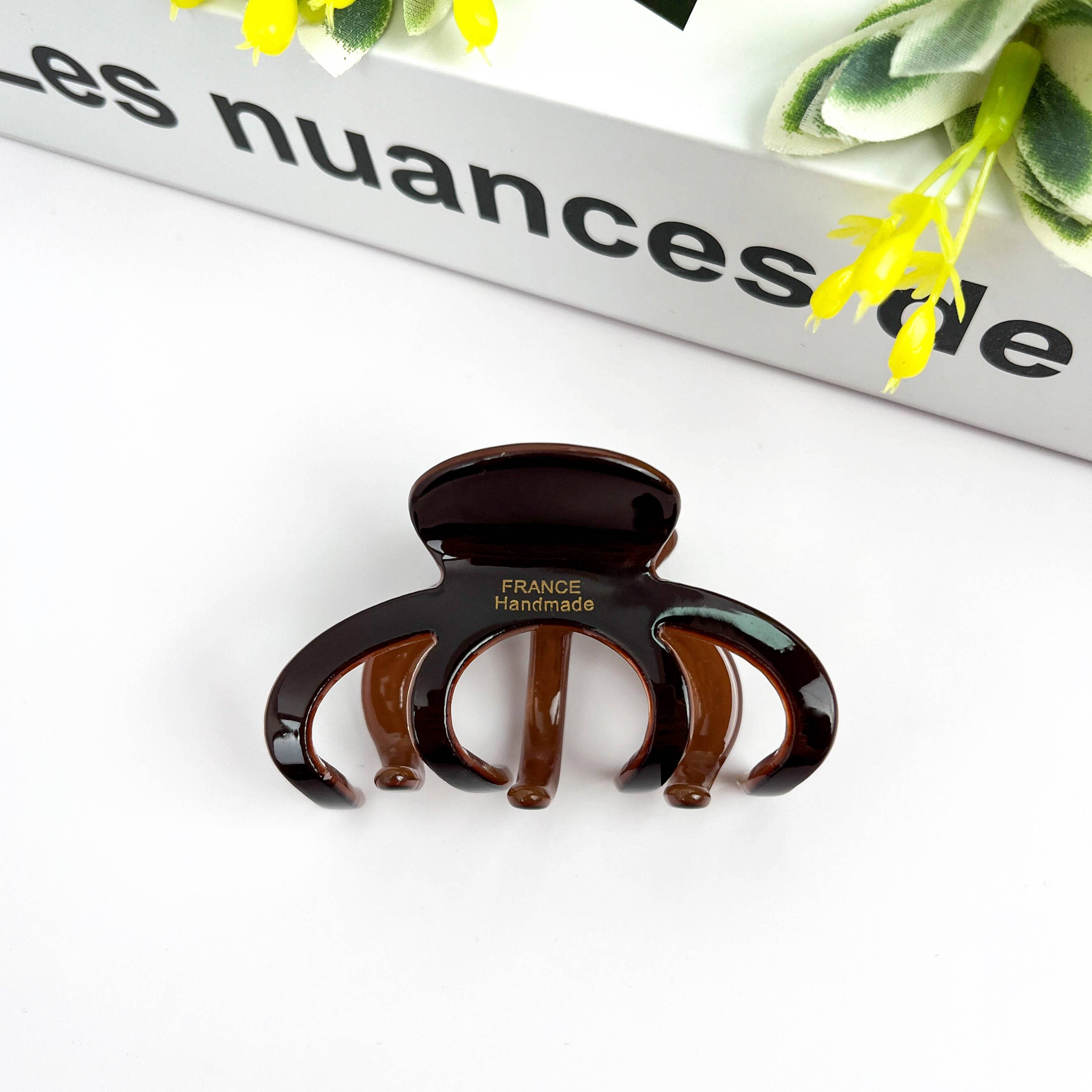 Pink medium DORA hair clip with a sleek, curved design, perfect for styling medium-length hair.