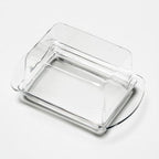 Clear glass butter dish by Heim Söhne with a lid, showcasing a small, elegant container for serving butter.