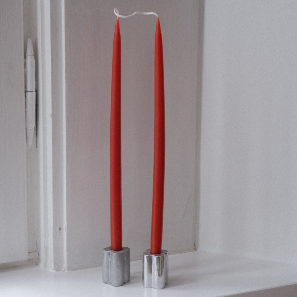 Set of four rust-colored hand-dipped stearin candles, 28 cm tall, by Kunstindustrien, displayed together in the image.