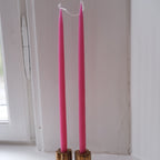 Set of four 28 cm cerise hand-dipped stearin candles by Kunstindustrien, displayed together on a neutral background.